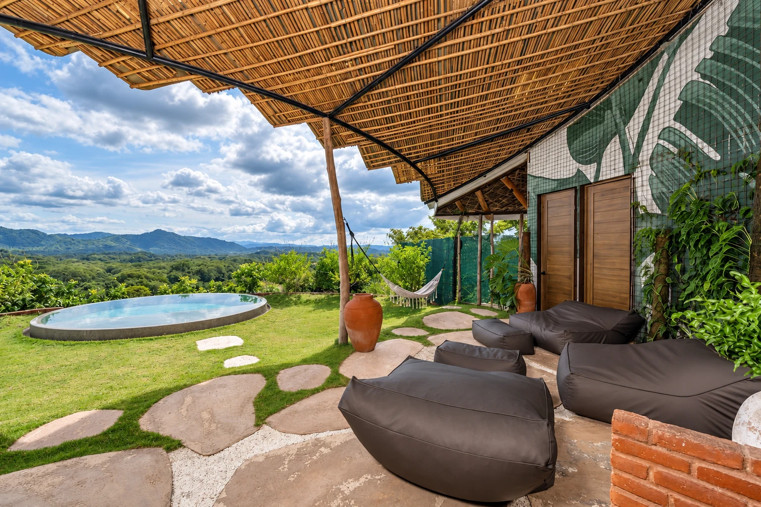 Casa Okma’s shaded terrace opening onto the circular infinity pool and Guanacaste mountains